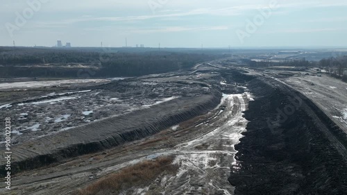 Aerial drone view of Open pit mine, industrial dirty black landscape around mine. areas after open pit mine, environmental pollution. photo