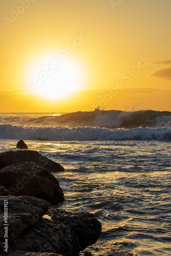 sunrise over the sea with crashing waves photo