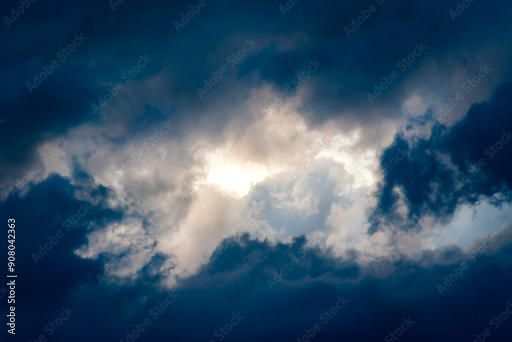 Obraz premium Dark and Dramatic Storm Clouds framing a clear sky Area Background
