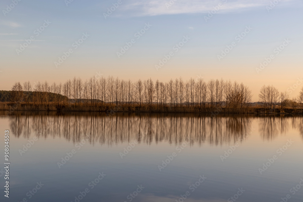 reflection of trees at sunset, river with reflection reflection of trees at sunset, river with reflection