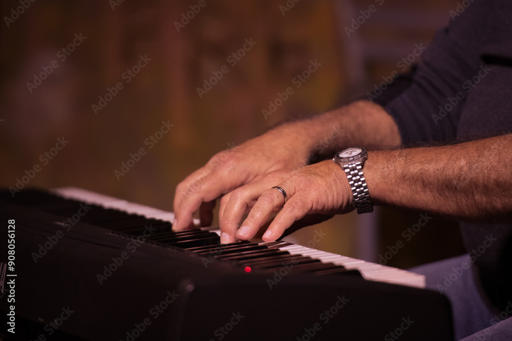 Close-up of a musician's hands playing a keyboard, highlighting the intricate movements and focus. The background is artistically blurred. Close-up of a musician's hands playing a keyboard, highlighting the intricate movements and focus. The background is artistically blurred.