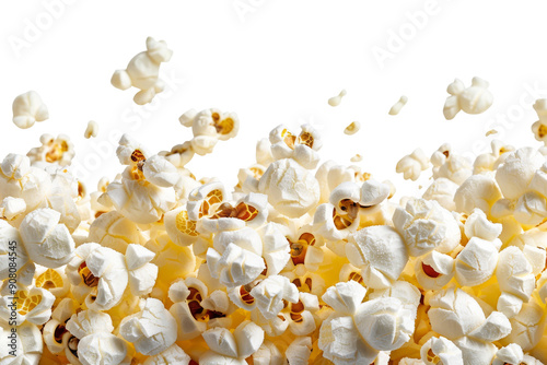 Close-up of a pile of freshly popped popcorn, with some pieces flying off the top.  The popcorn is a perfect example of a movie night snack.