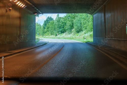 An empty road tunnel on a highway with no cars.