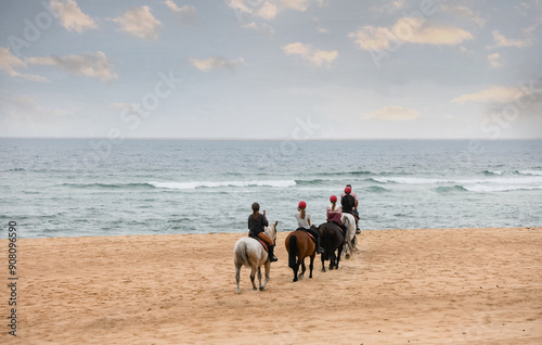 Group of riders riding horses in the southwest of France at sunset.