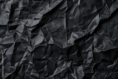 A black rolled paper texture with wrinkles, captured in a matte photo