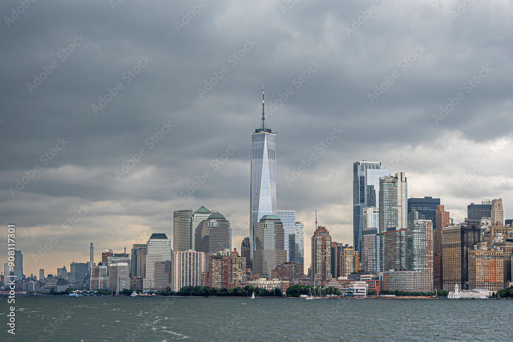 Fototapeta premium New York, NY, USA - August 4, 2023: Manhattan skyline N of Battery Park under gray intimidating cloudscape, seen from the SW