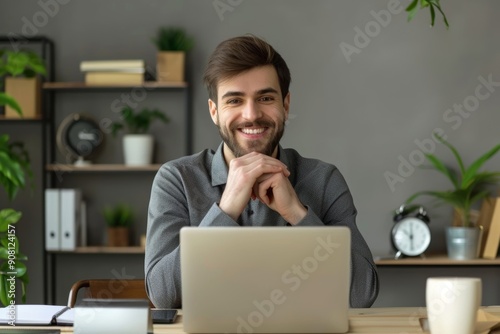 Happy young business man sitting with smartphone and laptop at desk, Generative AI