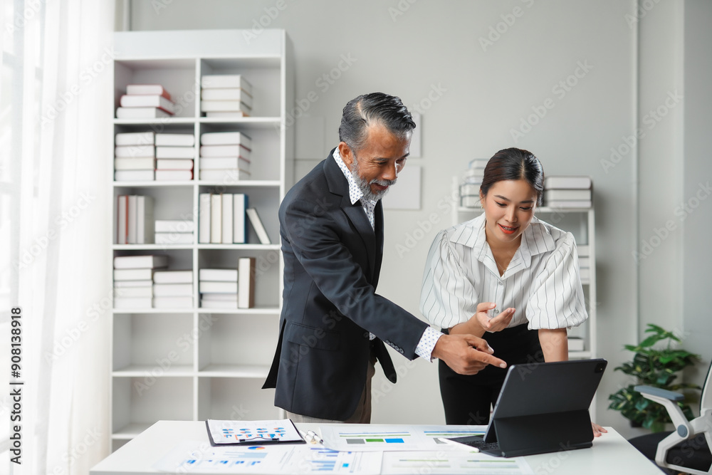 Business team working together on new project with tablet and financial reports in modern office Business team working together on new project with tablet and financial reports in modern office
