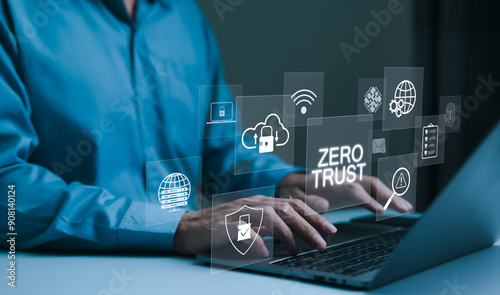 Zero Trust Security Concept. A person types on a laptop with virtual icons zero trust security, cloud protection, business information network security, shields, connectivity, cybersecurity measures,