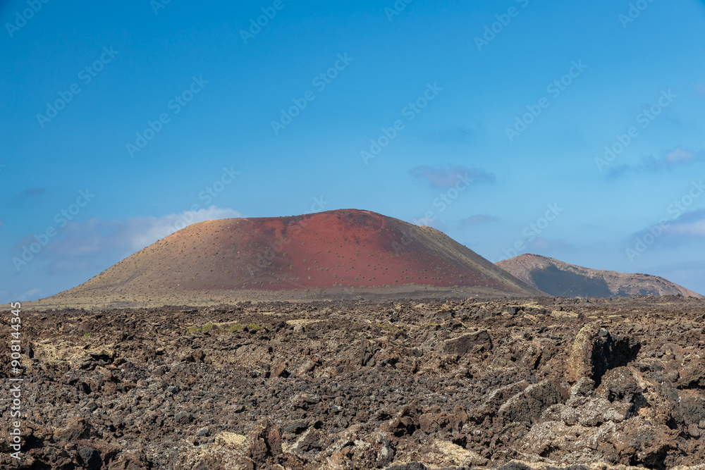 Typical Lanzarote landscape with an extinct volcano in the background, Canary Islands