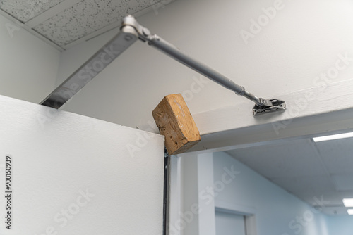 Wood doorstopper to hold office door open photo