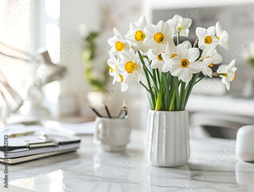 White daffodils in a vase on a white table