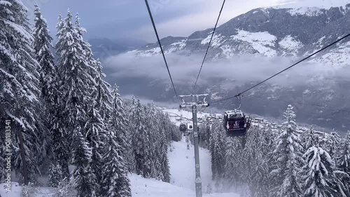 Ski lift over the slopes of Courchevel ski resort by winter