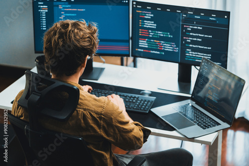 Bild auf Leinwand IT developer working online software development on pc monitors at modern home office on coding application screens, creating updated latest program firmware information version concept