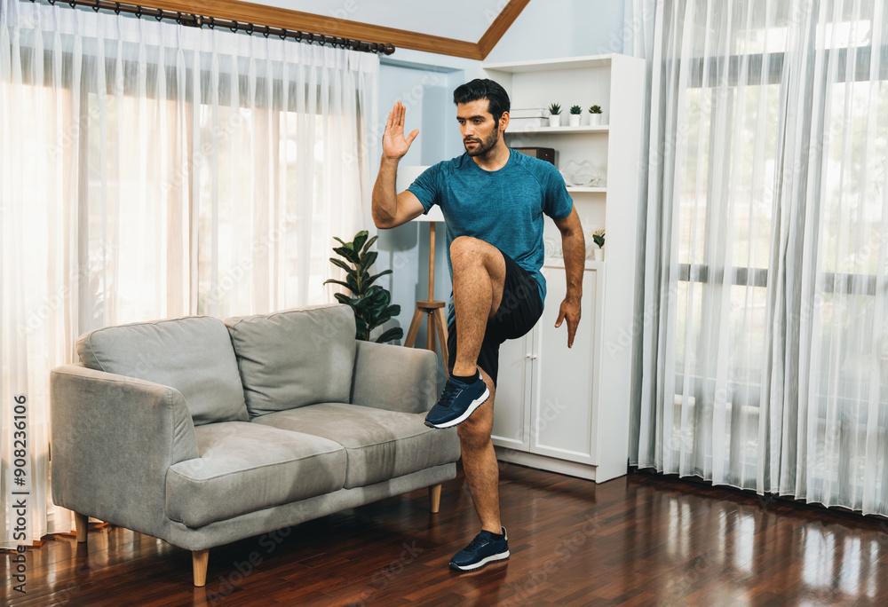 Fototapeta premium Athletic and sporty man running posture at home body workout exercise session for fit physique and healthy sport lifestyle at home. Gaiety home exercise workout training.