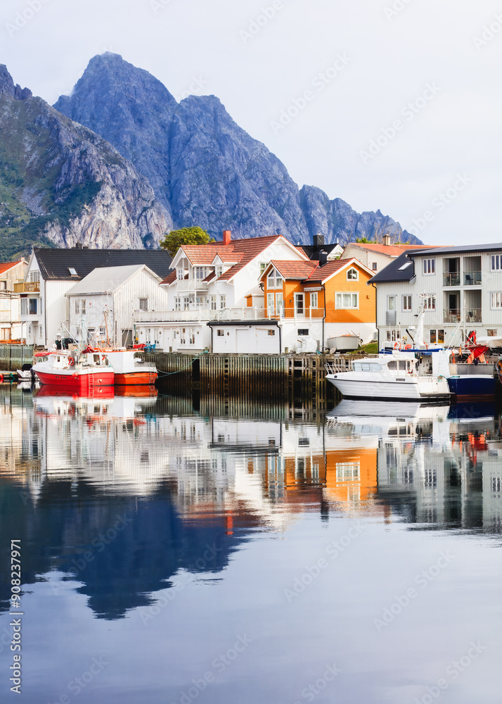 Beautiful harbor view with reflections in Henningsvær, less crowded cold climate destinations trend to escape from summer heat. Lofoten Islands, Norway Beautiful harbor view with reflections in Henningsvær, less crowded cold climate destinations trend to escape from summer heat. Lofoten Islands, Norway