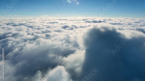 Slowly ascending above a thick layer of clouds revealing a panoramic view of a cloud bank stretching as far as the eye can see. photo