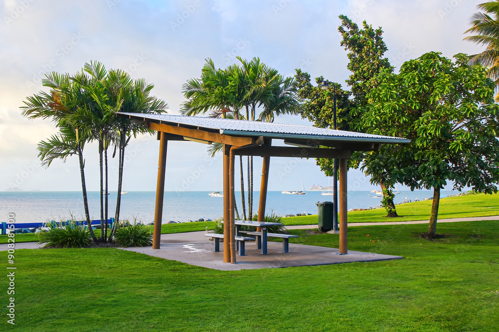 Picnic table on the waterfront of Airlie Beach on the coast of Queensland facing the Whitsunday Islands in the Pacific Ocean, Australia