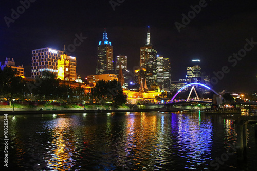 Flinders Street Station as seen from the Sandridge Bridge over the Yarra River at night in Downtown Melbourne, Victoria, Australia photo