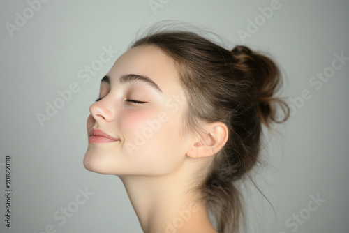 A close up of a girl's face with her eyes closed