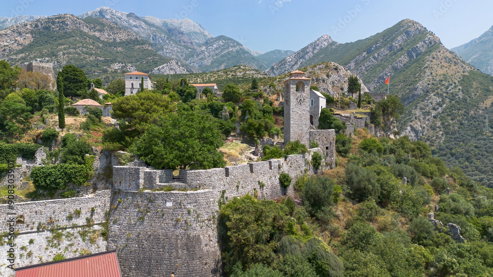 Obraz premium Aerial view of the clock tower of Stari Bar (Old Town of Bar), located right by the walls of the ancient city now in ruins at the foot of Mount Rumija in Montenegro