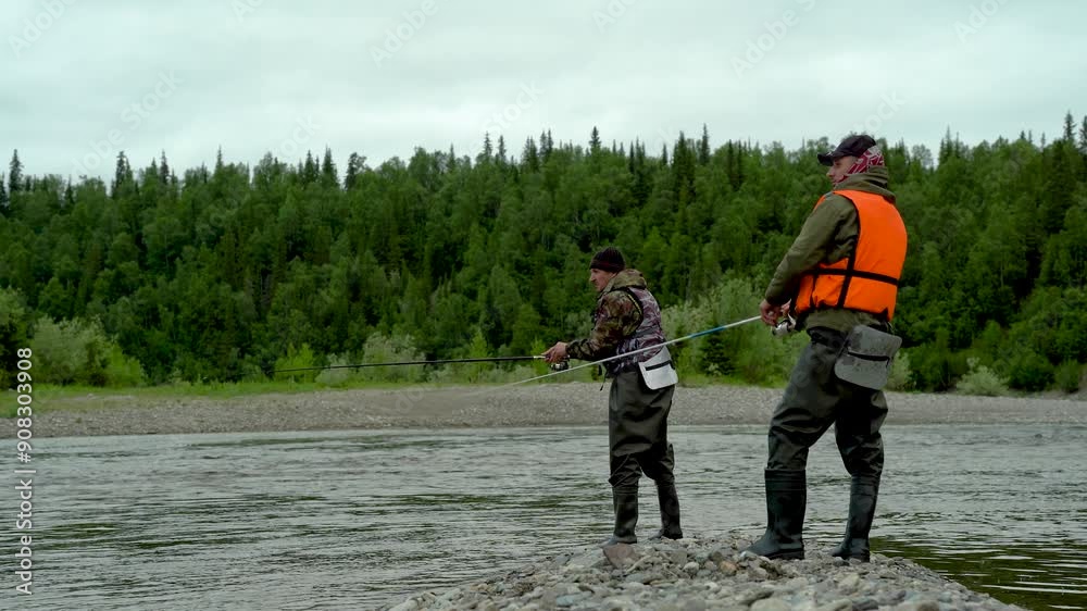 Fishermen catch and land fish on the river Fishermen catch and land fish on the river