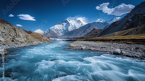 A flowing stream with mountains in the background photo