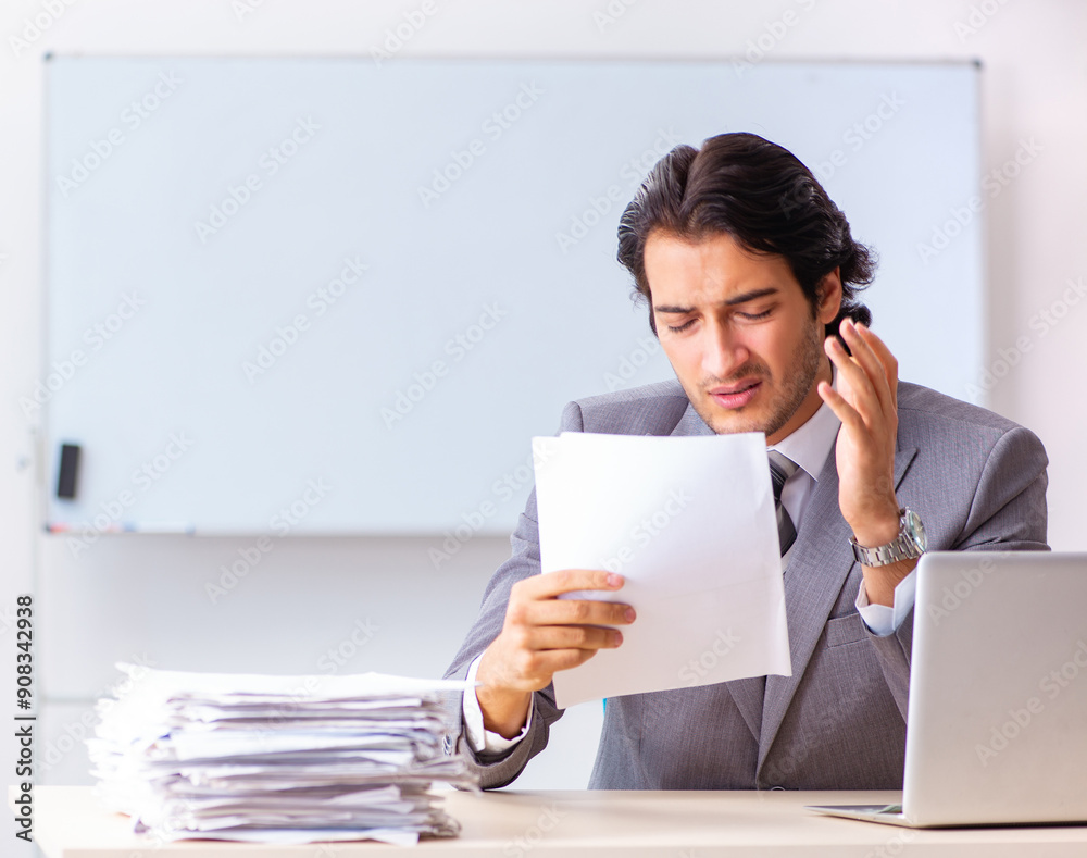 Young handsome businessman employee in the office Young handsome businessman employee in the office