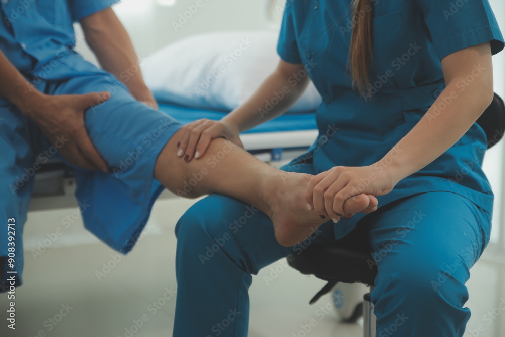 Physical therapists work with patients in close-up clinics. The concept of rehabilitation of physical health, the doctor gives advice to the patient. Ankle problems and muscle injuries