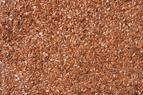 Linseed or flaxseed background, brown flax seeds. Top view, flat lay.
