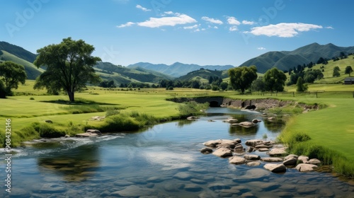 Tranquil rural landscape with houses by a flowing river under a bright blue sky.