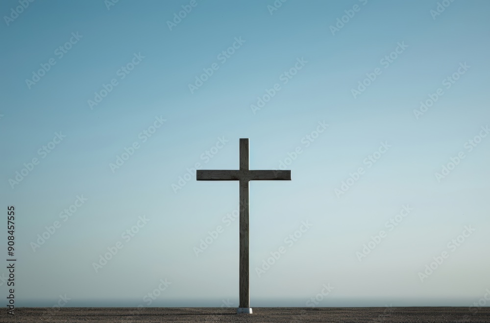 A solitary cross against a clear blue sky symbolizing faith and hope in a tranquil setting. A solitary cross against a clear blue sky symbolizing faith and hope in a tranquil setting.