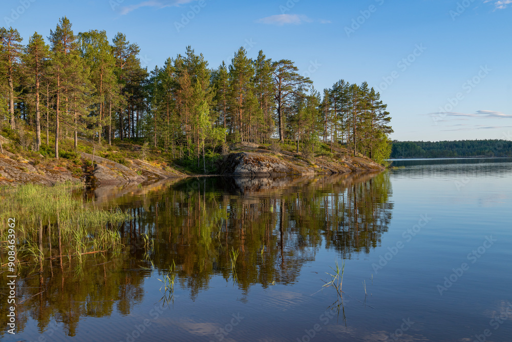 The shore of Koyonsaari island on a warm June evening. Karelia, Russia The shore of Koyonsaari island on a warm June evening. Karelia, Russia