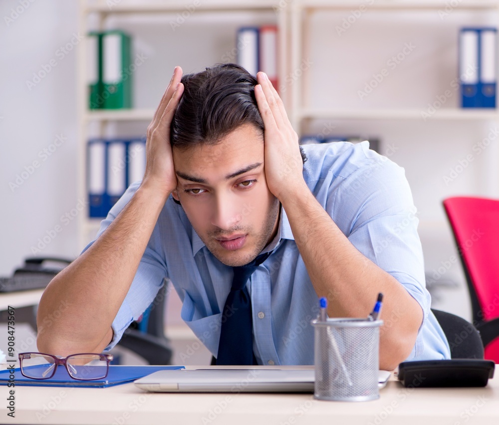 Young male businessman employee unhappy with excessive work Young male businessman employee unhappy with excessive work
