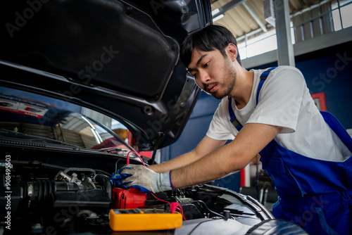 Professional Auto Mechanic Performing Vehicle Inspection and Maintenance in Modern Garage with Digital Tools and Technology