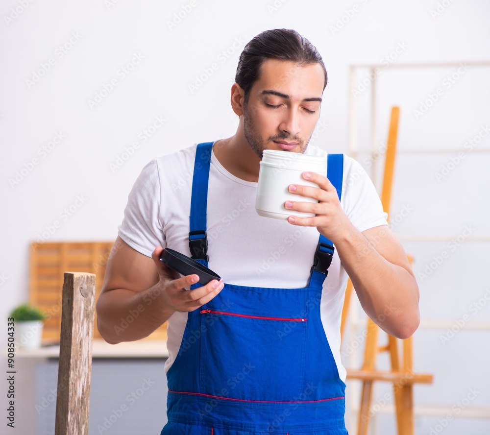 Young male contractor working in workshop Young male contractor working in workshop
