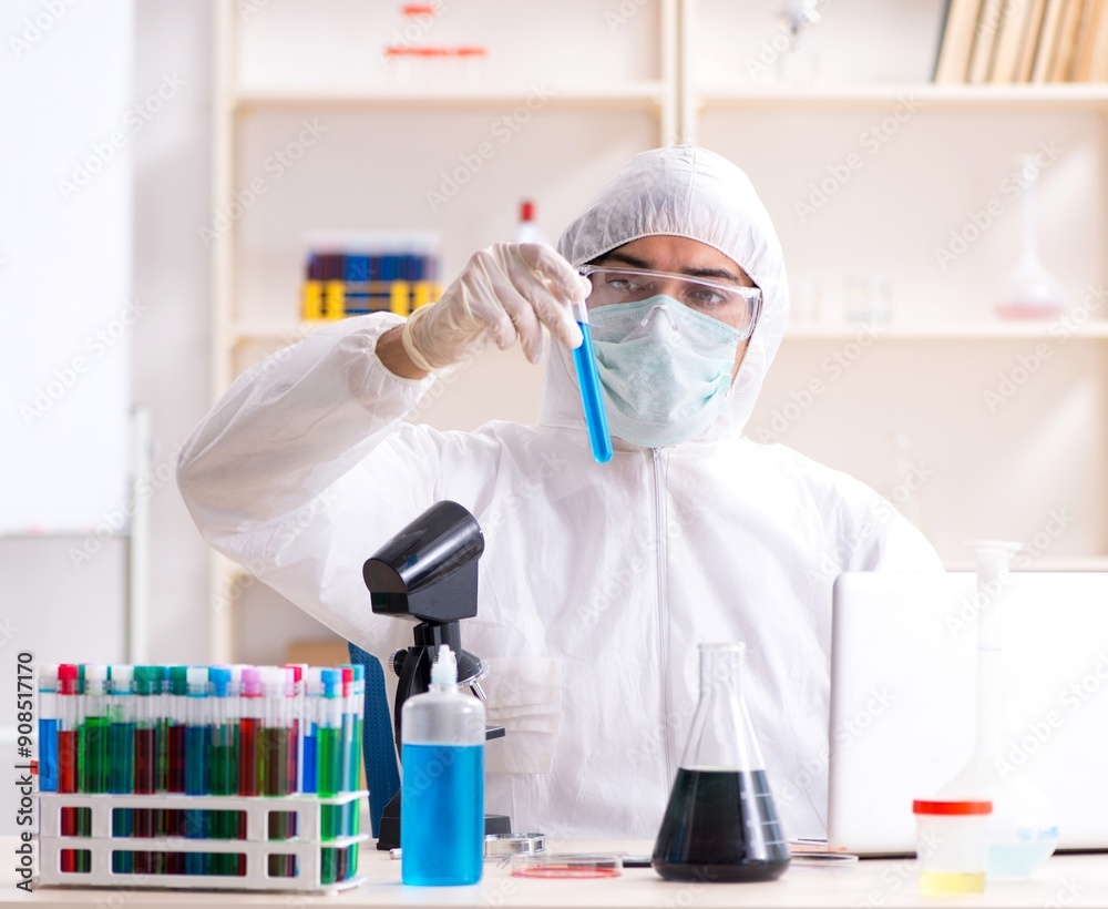 Young handsome chemist working in the lab Young handsome chemist working in the lab