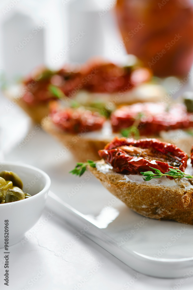 Close-up view of bruschetta with sun-dried tomatoes and capers Close-up view of bruschetta with sun-dried tomatoes and capers