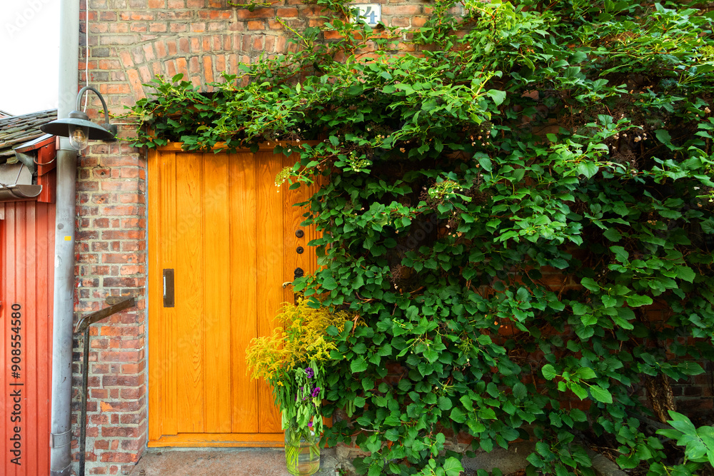 Beautiful small, wooden front door. Old architecture. Oslo. Norway. Old architecture Beautiful small, wooden front door. Old architecture. Oslo. Norway. Old architecture