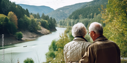 Elderly couple enjoying the autumn at a lake photo