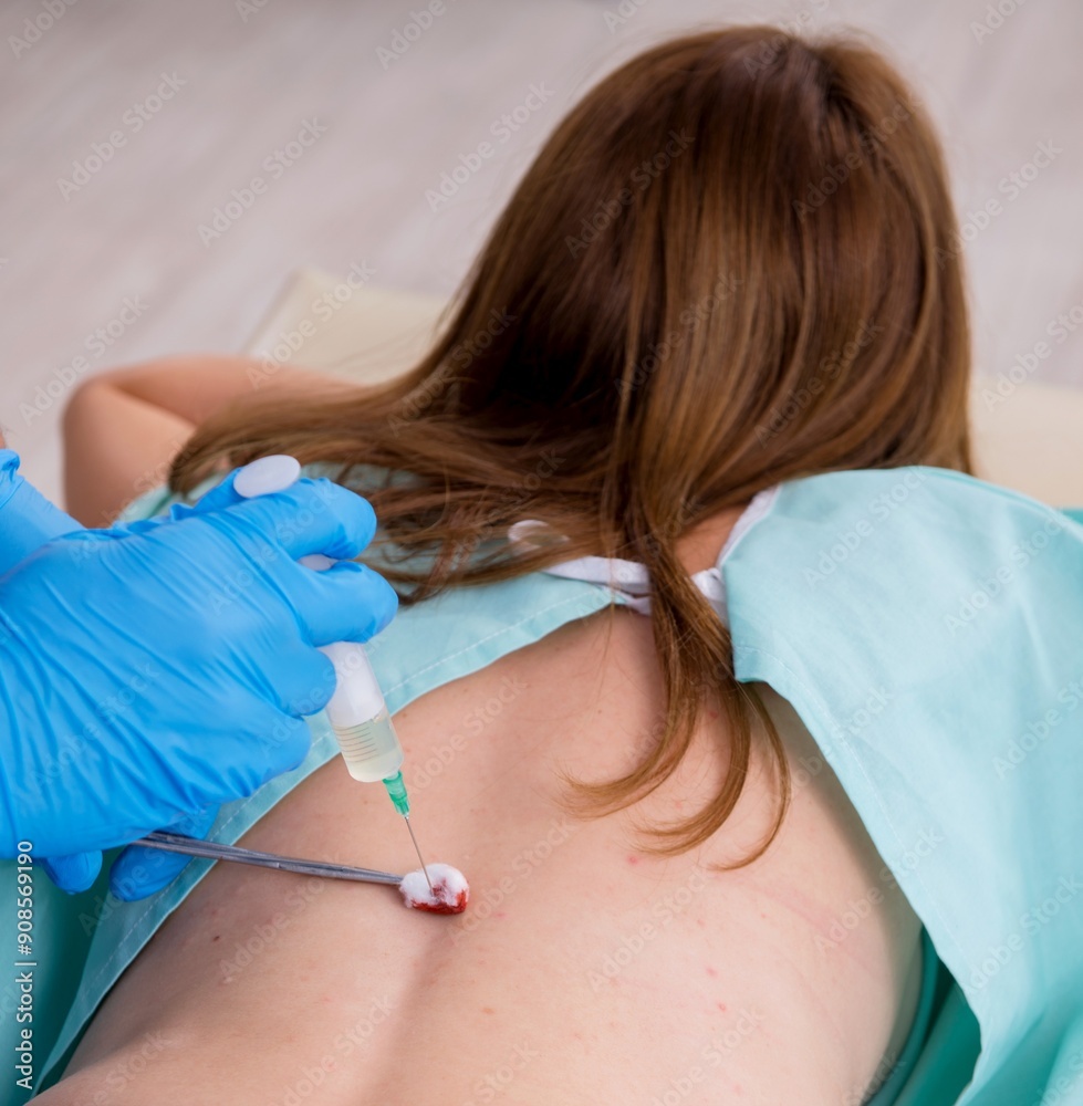 Young back injured woman visiting male doctor chiropractor Young back injured woman visiting male doctor chiropractor