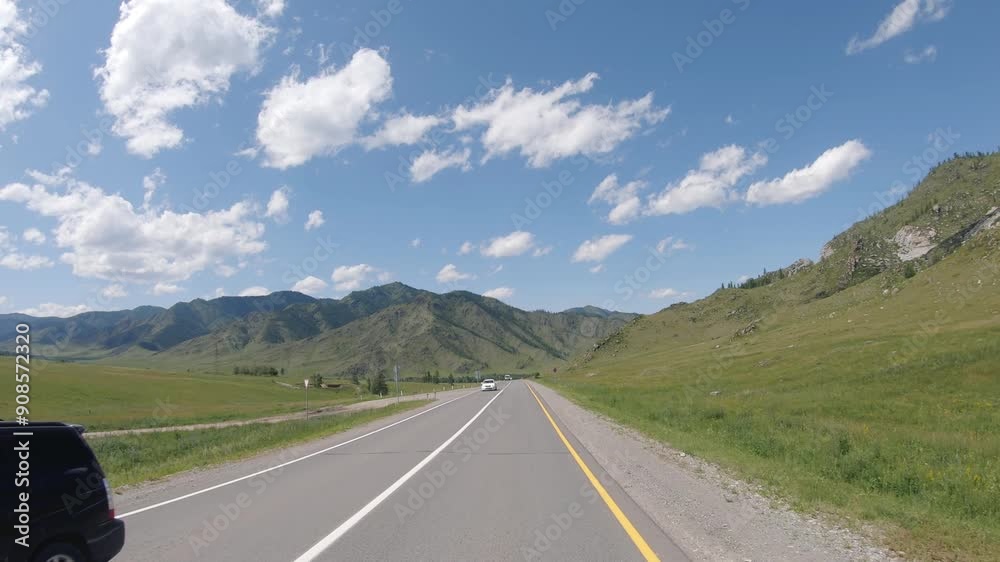 Driving in a car along the mountain road of the Chuya Highway or the Chuysky Trakt in Altai. Siberia, Russia Driving in a car along the mountain road of the Chuya Highway or the Chuysky Trakt in Altai. Siberia, Russia