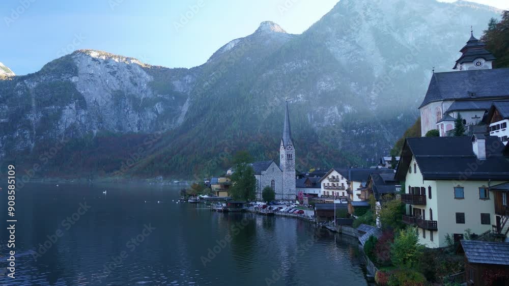 A beautiful lake with a town on the shore. The water is calm and the sky is cloudy A beautiful lake with a town on the shore. The water is calm and the sky is cloudy