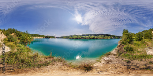 Fototapeta Naklejka Na Ścianę i Meble -  360 hdri panorama on limestone coast of huge green lake or river near pine forest with fluffy clouds in equirectangular full seamless spherical projection, VR content