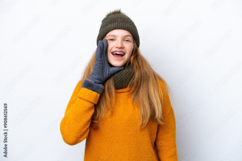 Teenager Russian girl wearing winter jacket isolated on white background shouting with mouth wide open Teenager Russian girl wearing winter jacket isolated on white background shouting with mouth wide open