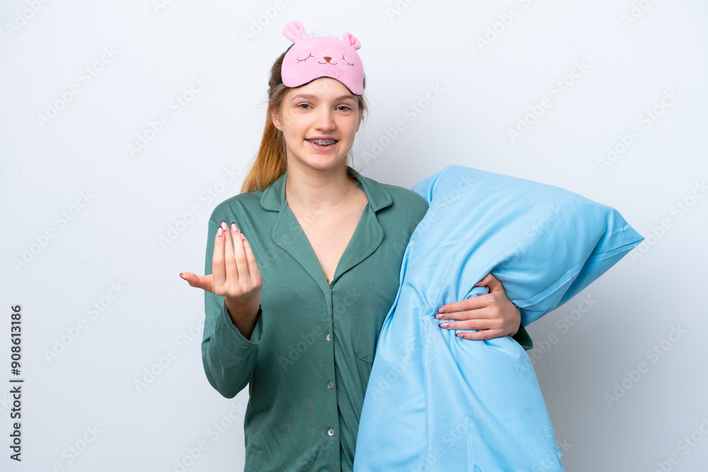 Teenager Russian girl isolated on white background in pajamas and inviting to come with hand. Happy that you came Teenager Russian girl isolated on white background in pajamas and inviting to come with hand. Happy that you came