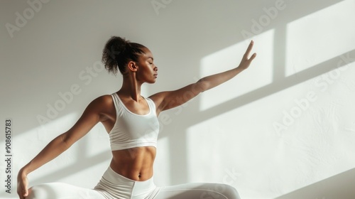 A yoga practitioner holding a graceful warrior pose, demonstrating balance and flexibility. The white background enhances the clarity of the pose and the serene expression on the 