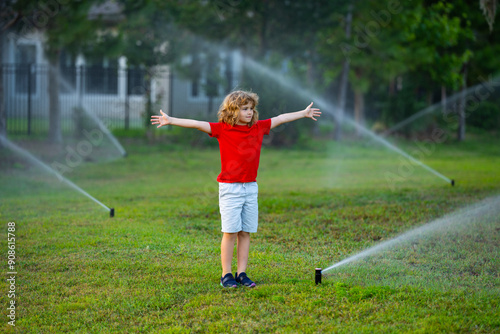 Wallpaper Mural Garden watering systems. Child play with watering sprinkler system in backyard. Little kid playing with garden watering hose in backyard. Child having fun with spray of water. Watering grass. Torontodigital.ca