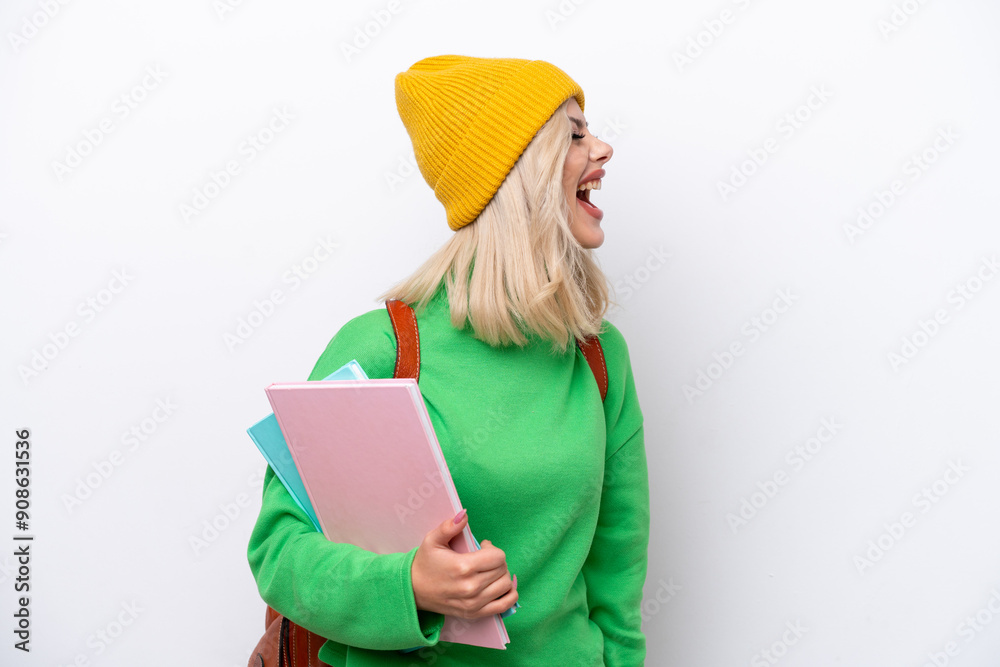 Young Russian student woman isolated on white background laughing in lateral position Young Russian student woman isolated on white background laughing in lateral position