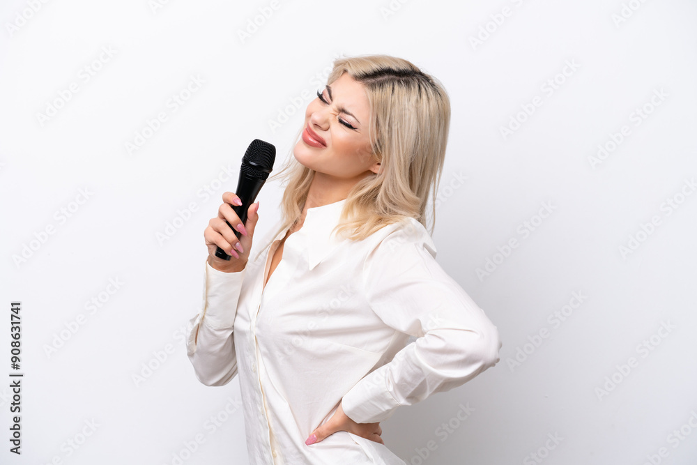 Young singer woman picking up a microphone isolated on white background suffering from backache for having made an effort Young singer woman picking up a microphone isolated on white background suffering from backache for having made an effort